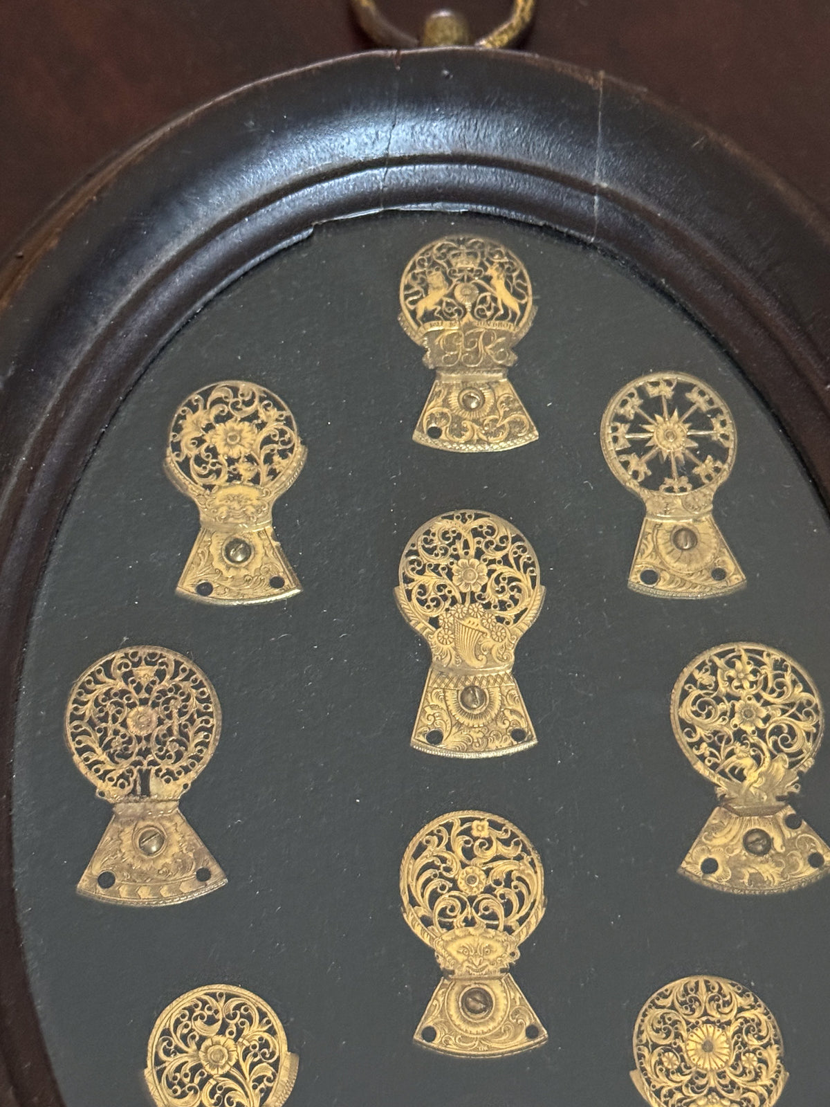 A Framed Collection of Antique Verge Watch Cocks